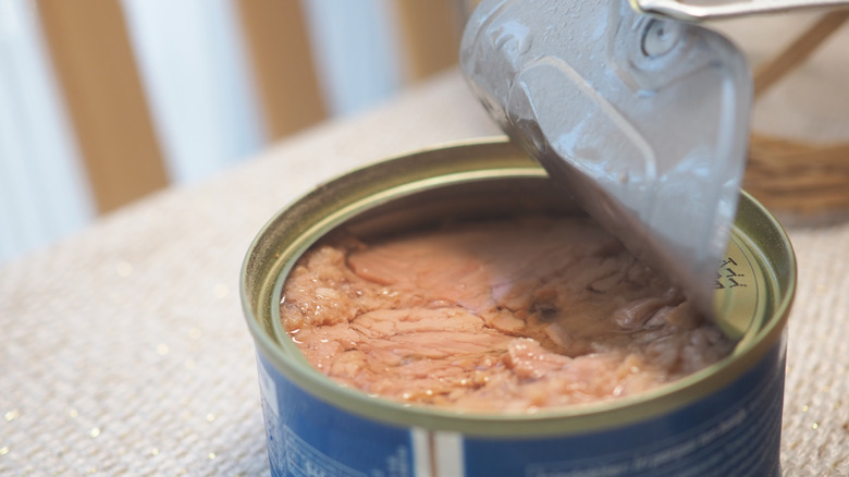 A can of tuna being pulled open