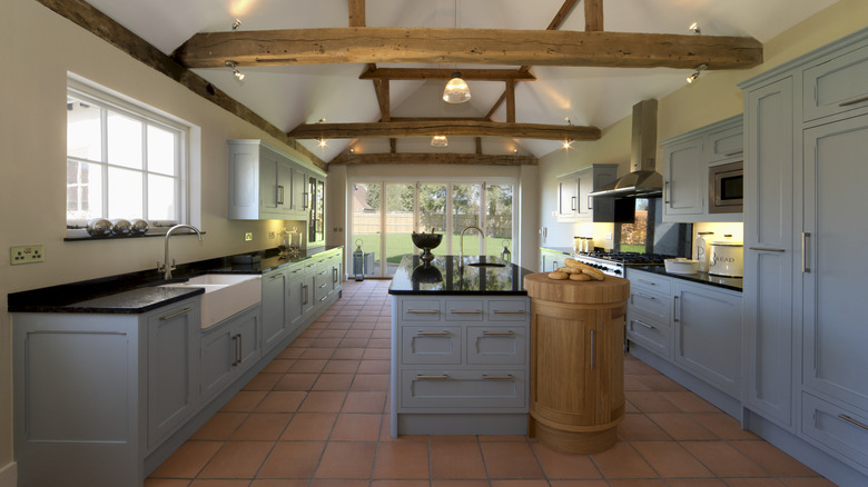 A view of a Tuscan-style kitchen with terracotta flooring