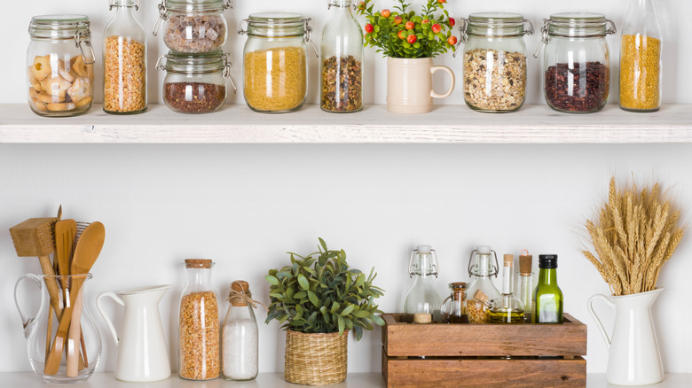 Pantry essentials stored on open shelves and within a wooden crate