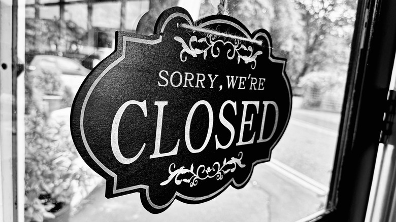 Black and white sign saying "Sorry, we're closed"