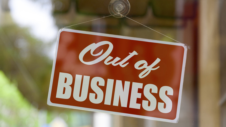 A red going out of business sign hanging in a window