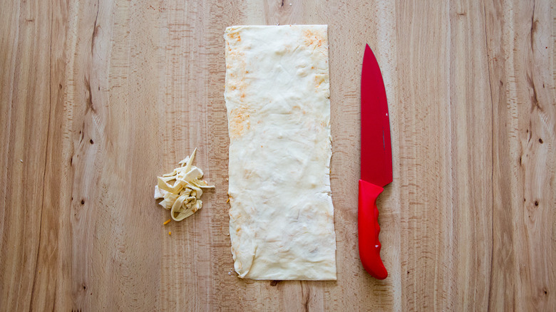 Folded puff pastry on table