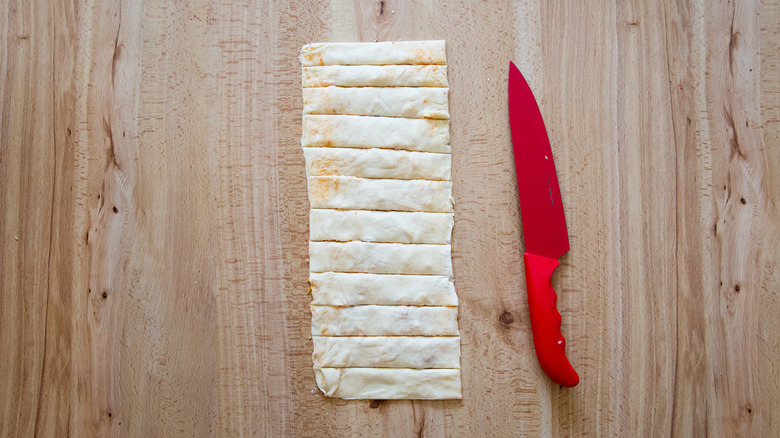 Puff pastry strips on table