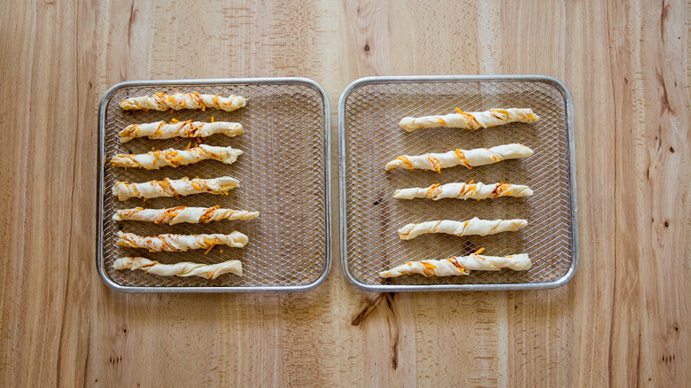 raw cheese straws on rack