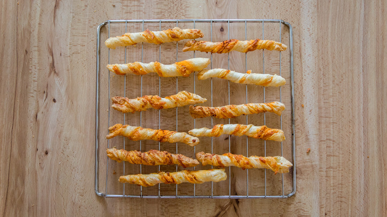 cooked cheese straws on rack
