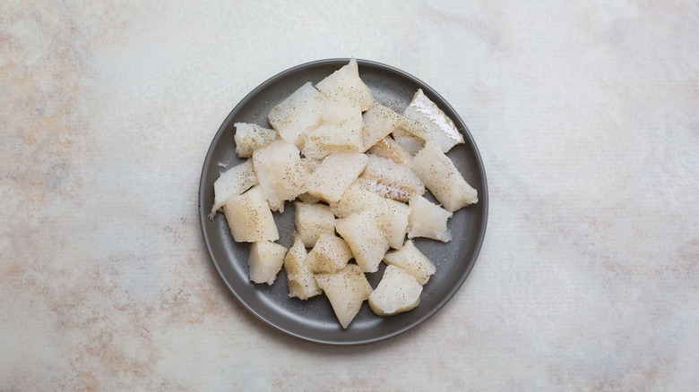 raw cod pieces on plate