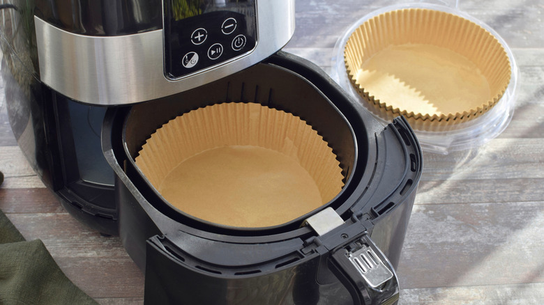 Air fryer on a counter with a liner