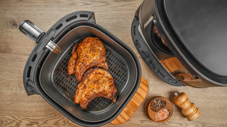 Two steaks in an air fryer basket