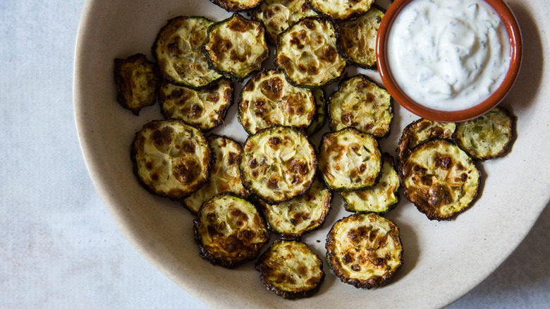 zucchini chips in beige bowl