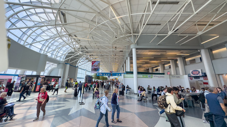 Travelers mill around an airport