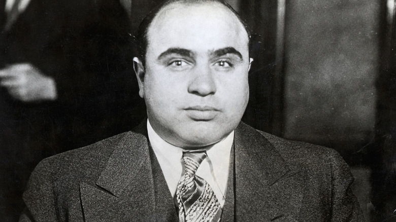 A black and white photo of Al Capone in a suit