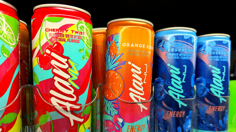 Cans of Alani Nu energy drinks on a store shelf