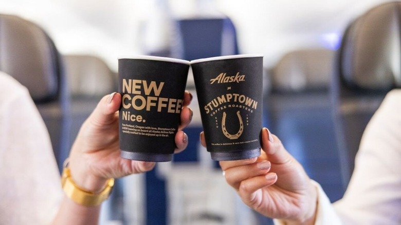 Alaska Airlines patrons hold Stumptown Coffee cups