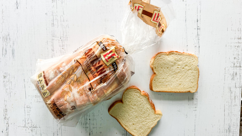 Package of L'Oven Artisan White Bread on white table