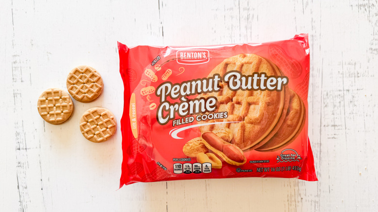Benton's peanut butter créme filled cookies and package on a white wooden surface