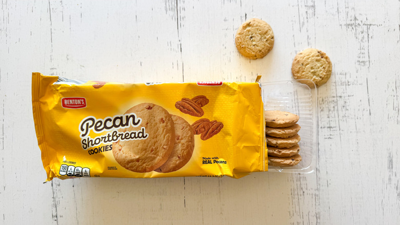 Benton's pecan shortbread cookies and package on a white wooden surface