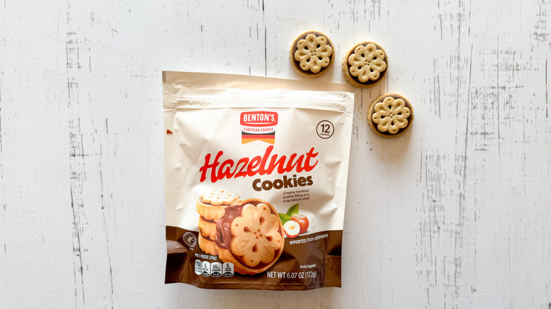 Benton's hazelnut cookies and bag on a white wooden surface