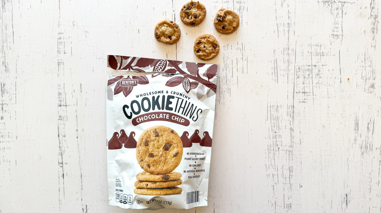 Benton's chocolate chip cookie thins and package on a white wooden surface