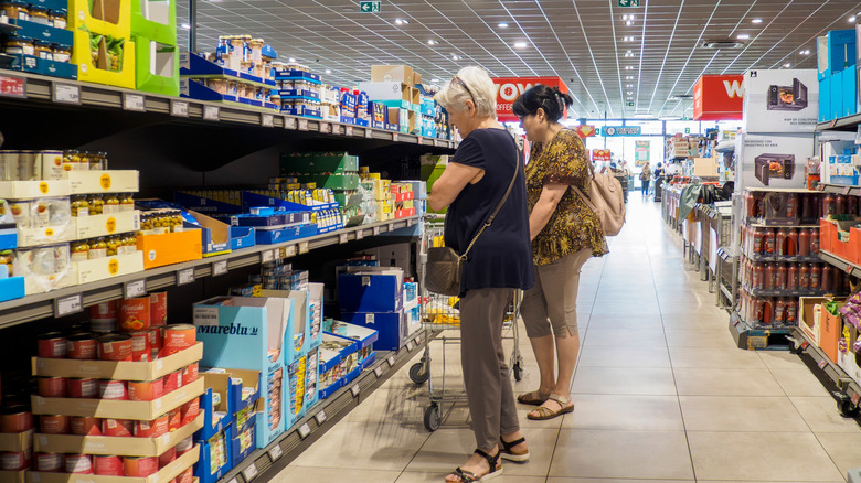 two women looking at the shelves in Aldi
