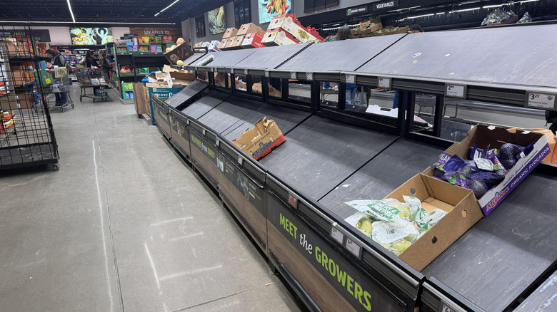Aldi produce aisle with no produce on the shelves