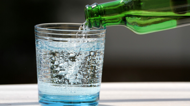 fizzy beverage being poured into cup