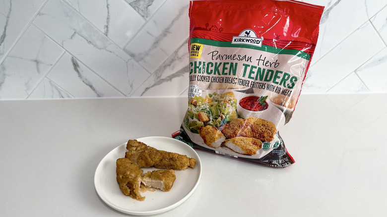 Kirkwood parmesan herb chicken tenders on a plate with product bag alongside