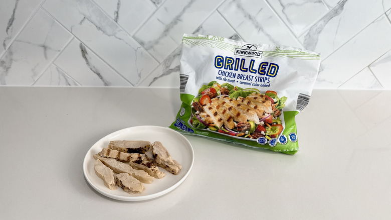 Kirkwood grilled chicken breast strips on a plate with product bag alongside