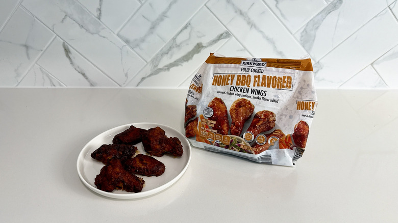 Kirkwood honey BBQ flavored chicken wings on a plate with product bag alongside