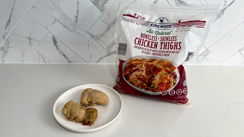 Kirkwood boneless skinless chicken thighs on a plate with product bag alongside