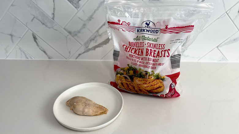 Kirkwood boneless skinless chicken breast on a plate with product bag alongside