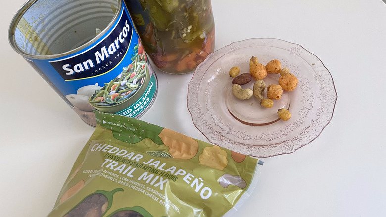 Trail mix and pickled jalapeno on table
