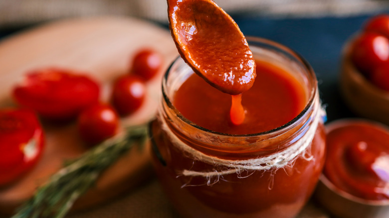 open jar of tomato sauce pictured close up from above