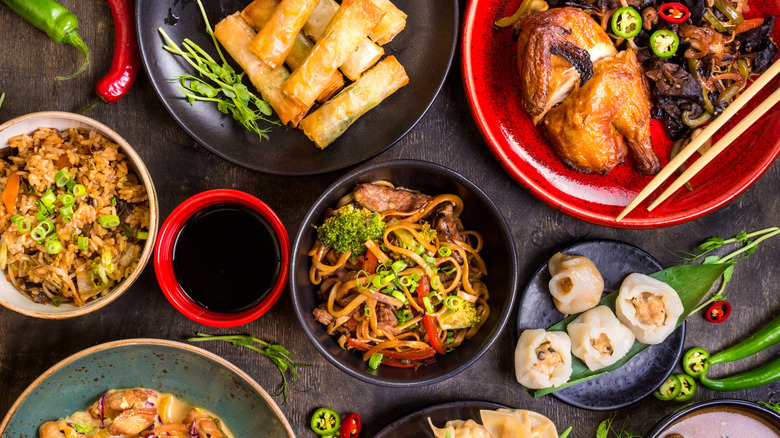 Overhead view of a variety of Chinese dishes laid out on a table