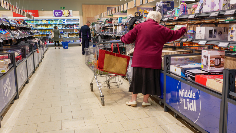 People shopping in the Middle of Lidl supermarket aisle