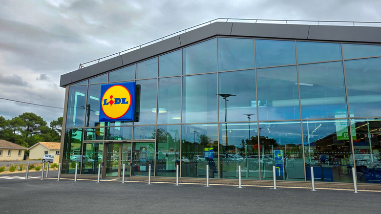 Modern glass facade of Lidl in France in front of empty parking lot