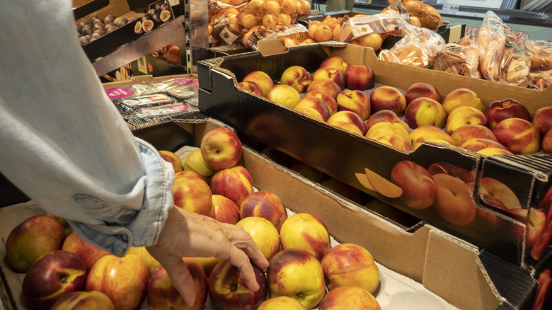 customer grabbing fruit at Lidl