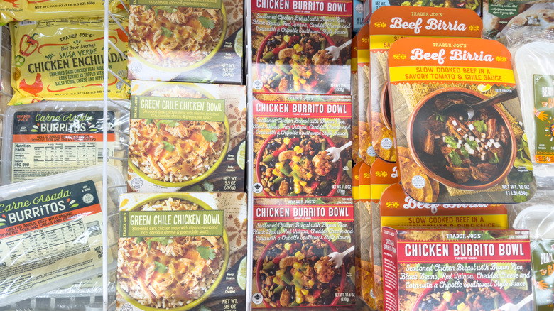 A variety of Trader Joe's Mexican frozen food, including carne asada burritos, chicken enchiladas, green chile chicken bowls, chicken burrito bowls, and beef birria.