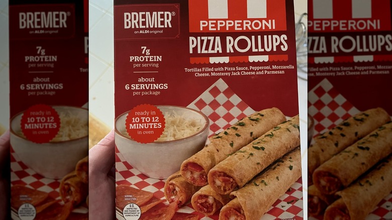 A person holding a box of Bremer Pepperoni Pizza Rollups from Aldi