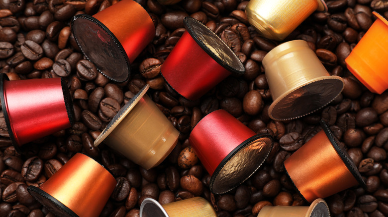 Coffee pods on top of coffee beans