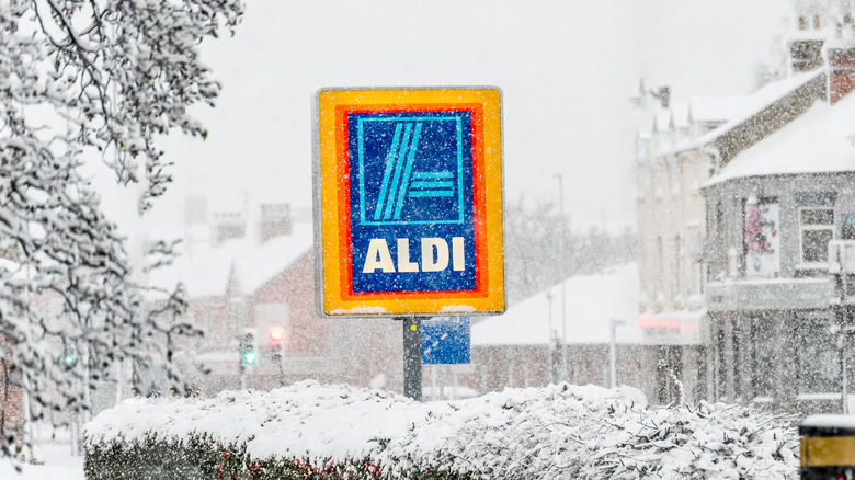 Bright Aldi sign surrounded by snow