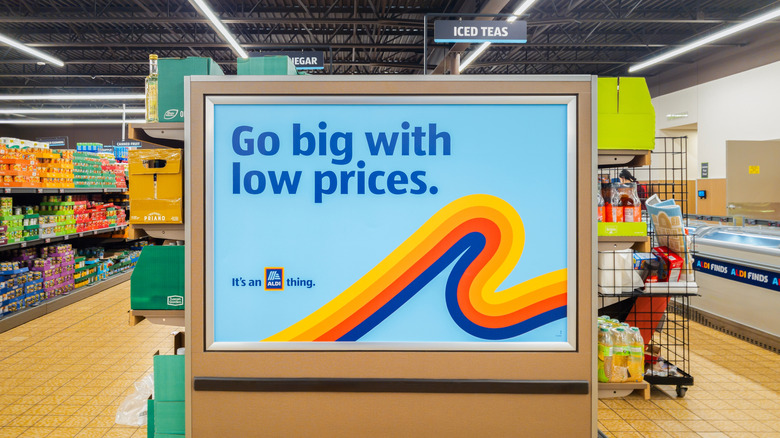 A large sign in an Aldi store, reading "Go big with low prices."