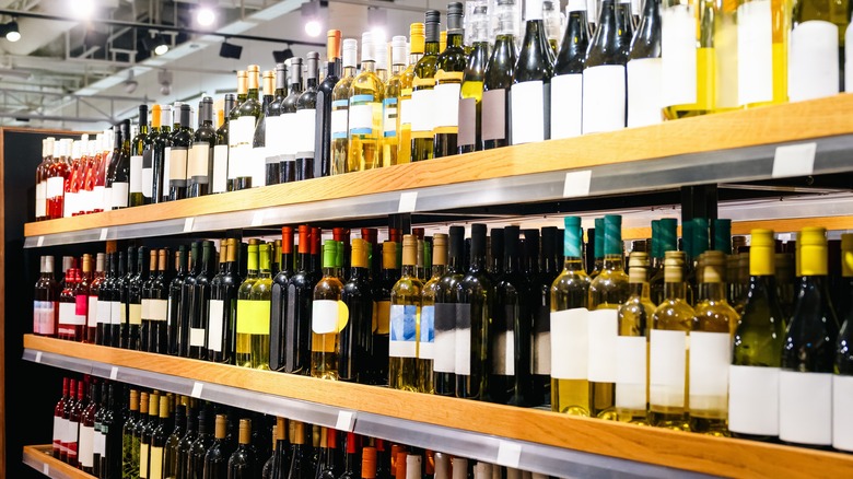 Many bottles of wine on a liquor shelf