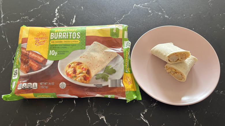 A pack of Aldi breakfast burritos and a plate with one cut in half