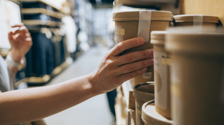 someone picking out soup at grocery store