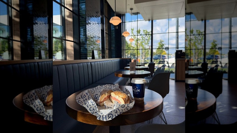a bagel and coffee on a table at H&H Bagels