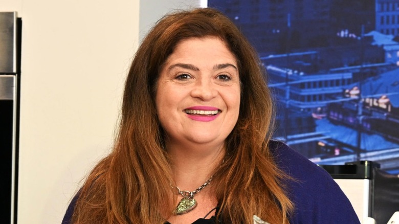 Alex Guarnaschelli smiles on stage while doing a demo.