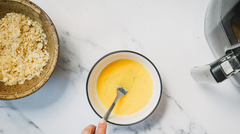 Mixing egg and brine in small bowl.