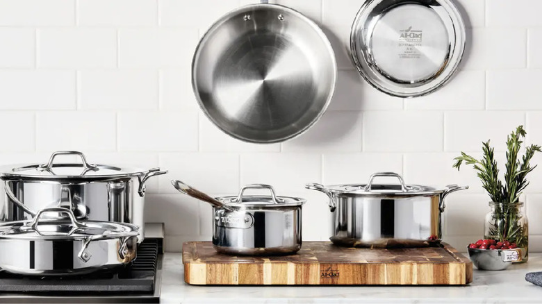 stack of various pots and pans, including All-Clad steel