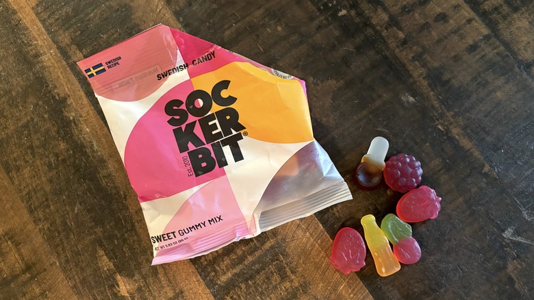 Sockerbit sweet gummy mix in bag and on wooden background.