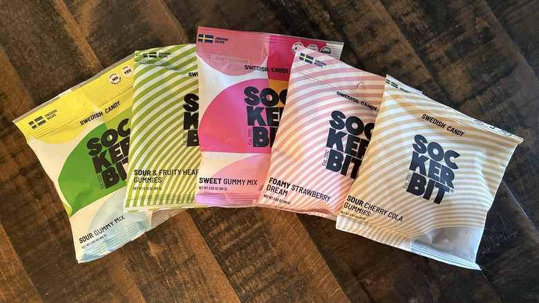 Sockerbit gummy candy in bags on wooden background.